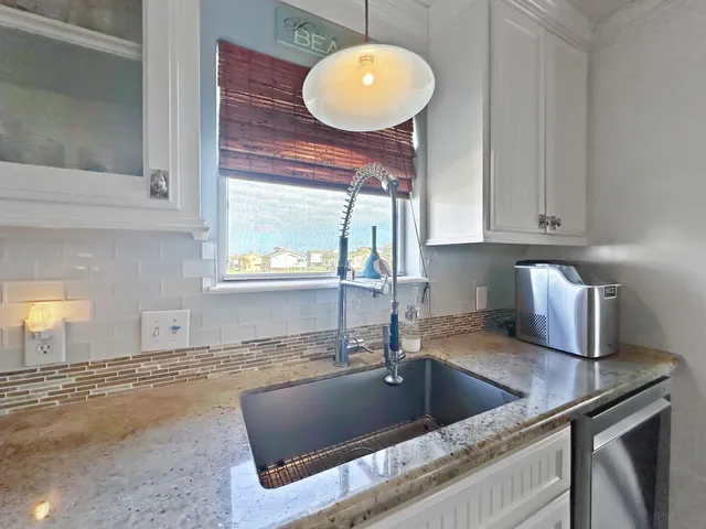 a kitchen with a sink and a stove top oven