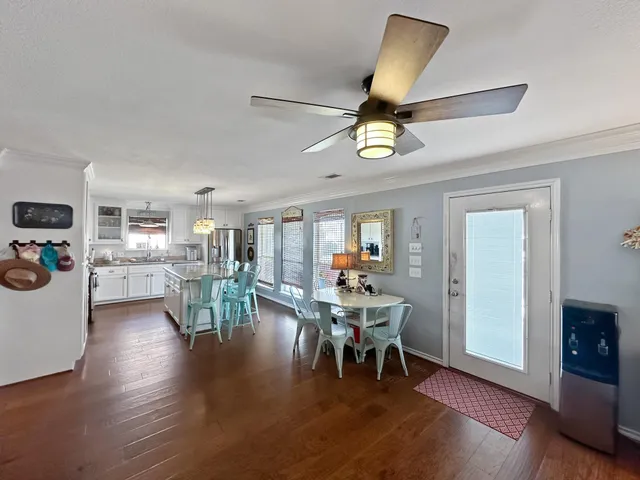 a living room with furniture and kitchen view