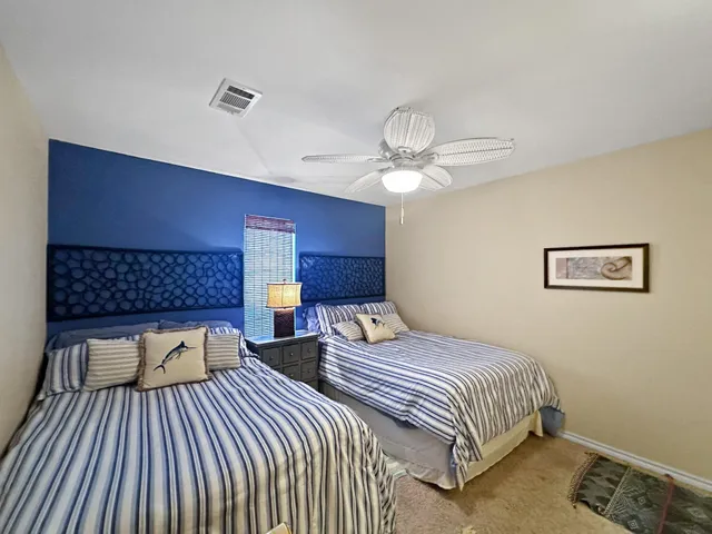 a bedroom with double bed and a chandelier