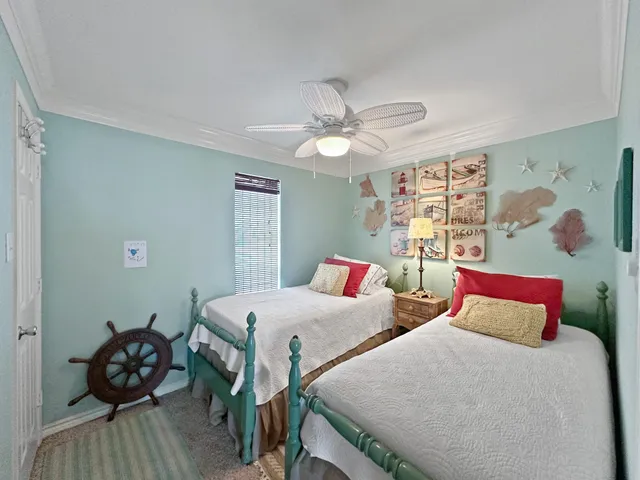 a bedroom with two beds and a chandelier