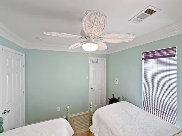 a bedroom with a white bed and a chandelier