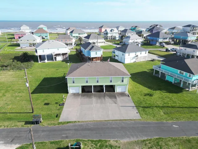 a aerial view of a house with a garden and lots of trees