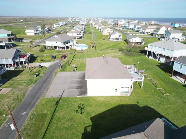 a aerial view of a house with a yard and potted plants