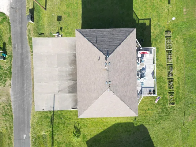 a view of house with a swimming pool and deck
