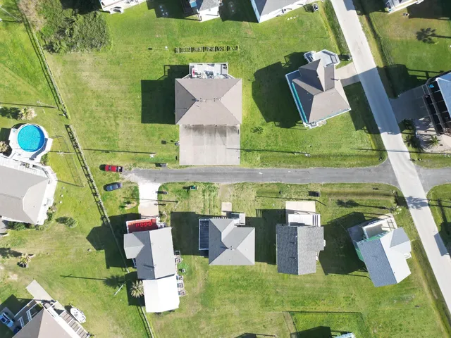 a front view of a house with a garden and yard