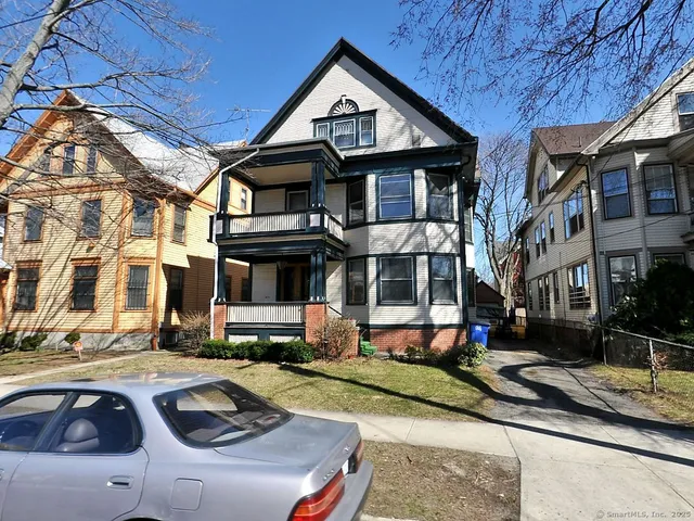 a front view of a residential apartment building with a yard