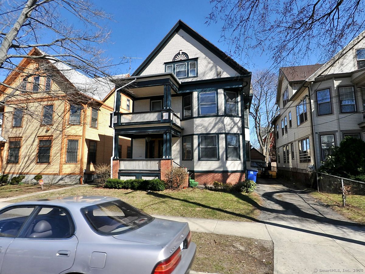 a front view of a residential apartment building with a yard
