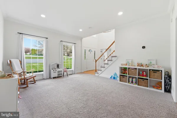 a view of a hallway with a white walls and stairs
