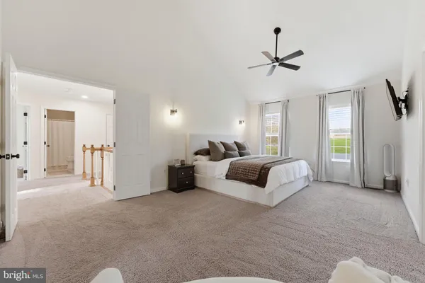 a bedroom with bed and a large window
