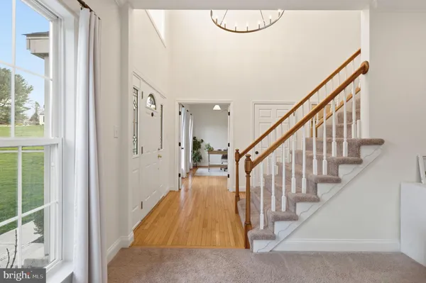 a kitchen with a refrigerator a stove top oven a sink dishwasher and a dining table with wooden floor