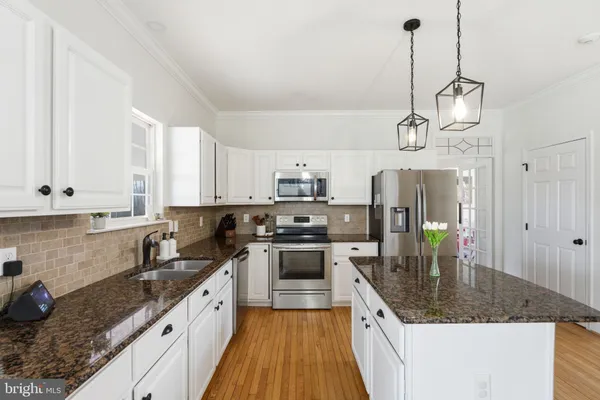 a view of a kitchen cabinets and wooden floor