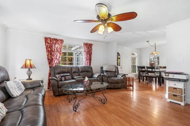 a living room with furniture and wooden floor
