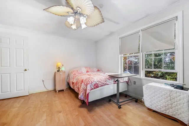 a bedroom with a bed and large windows