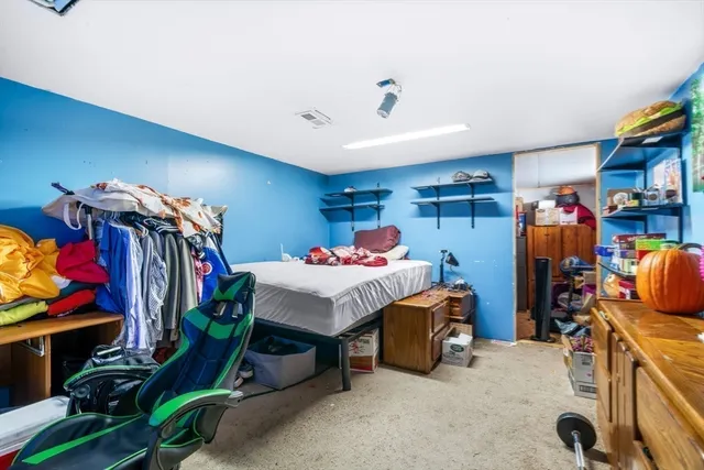 a bed room with a bed and a desk