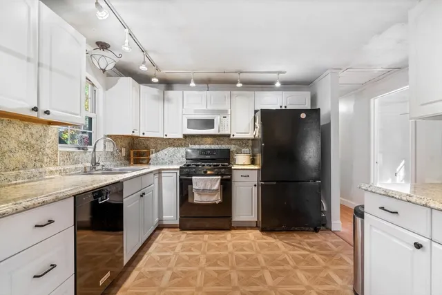 a kitchen with stainless steel appliances granite countertop a refrigerator sink and cabinets