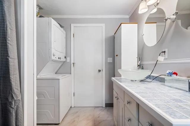 a kitchen with a sink vanity and a mirror