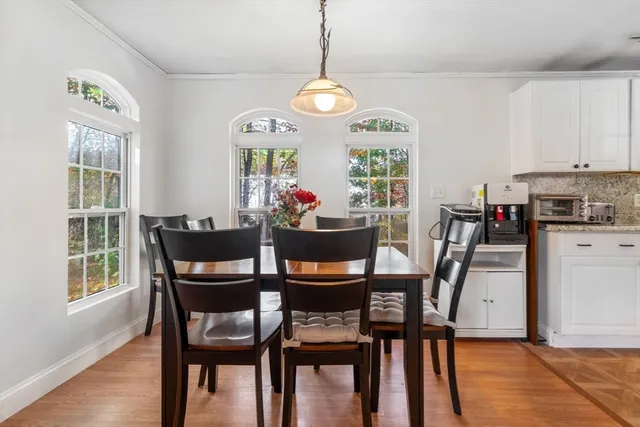 a view of a dining room with furniture window and wooden floor