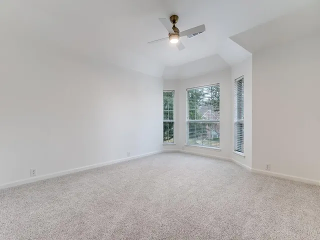 a view of room with a ceiling fan and window
