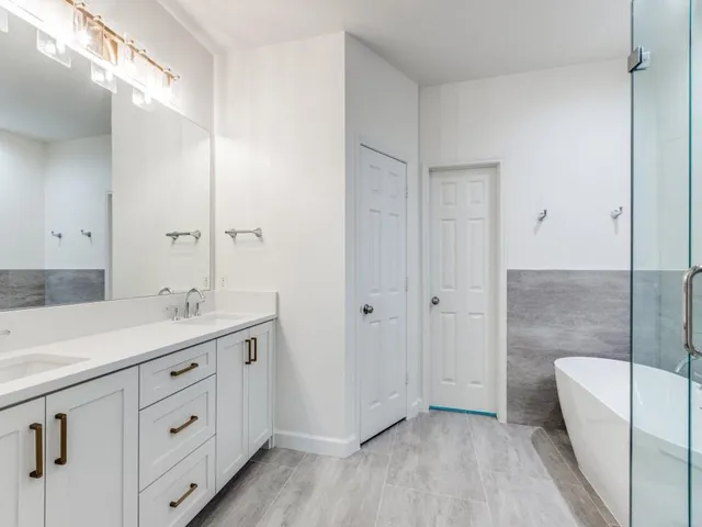 a bathroom with a double vanity sink and mirror