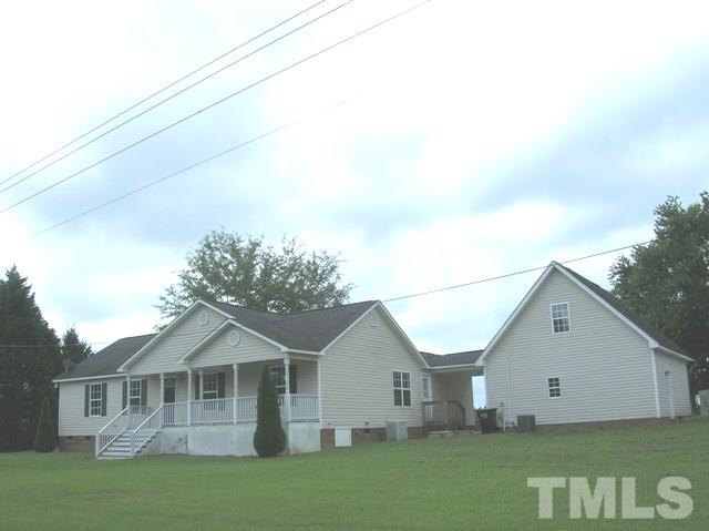 2695 Highway 42 Willow Spring, NC 27592 - Photo 1 of 22 a view of a yard in front of a house with large trees