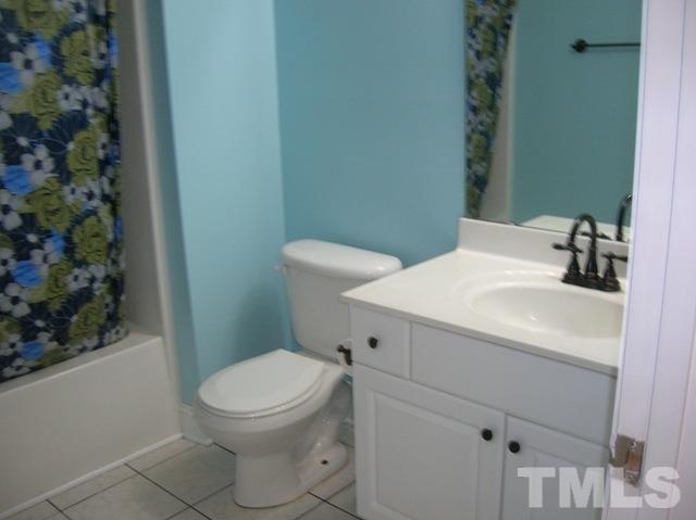 2695 Highway 42 Willow Spring, NC 27592 - Photo 12 of 22 a bathroom with a sink a toilet and mirror