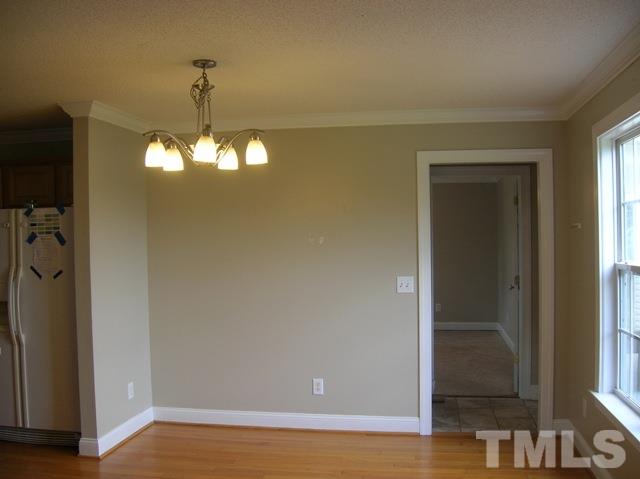 2695 Highway 42 Willow Spring, NC 27592 - Photo 13 of 22 a view of a livingroom with a chandelier fan and wooden floor