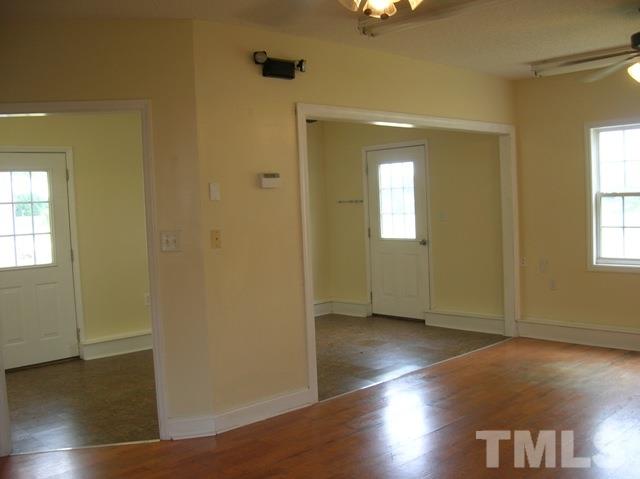 2695 Highway 42 Willow Spring, NC 27592 - Photo 14 of 22 an empty room with wooden floor and windows