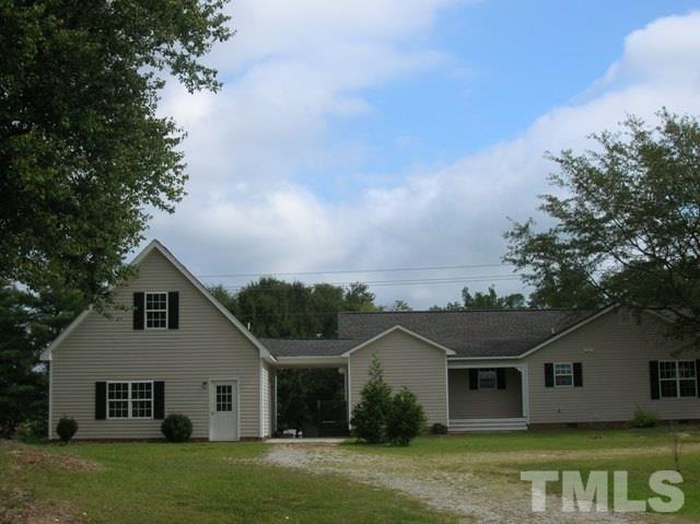2695 Highway 42 Willow Spring, NC 27592 - Photo 3 of 22 a view of a yard in front of a house with a large tree
