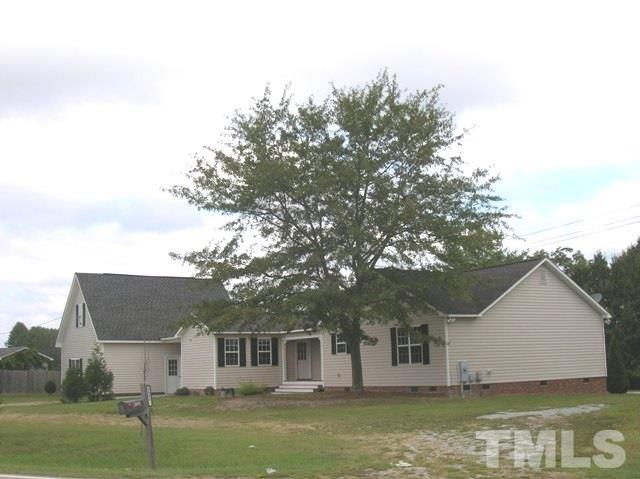 2695 Highway 42 Willow Spring, NC 27592 - Photo 21 of 22 a view of a large house with a large tree and a yard
