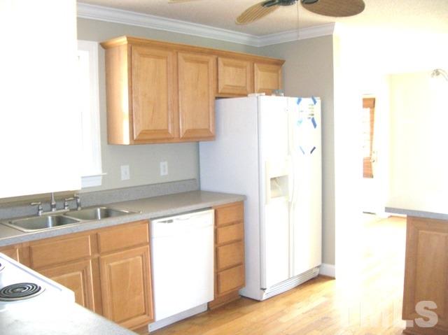 2695 Highway 42 Willow Spring, NC 27592 - Photo 5 of 22 a kitchen with a refrigerator sink and cabinets