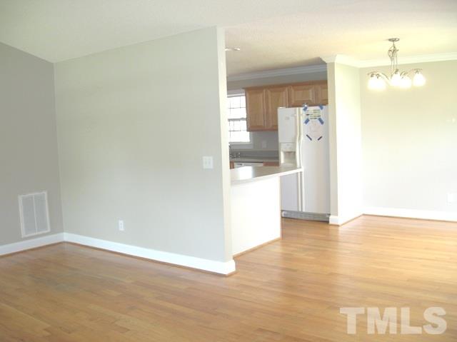 2695 Highway 42 Willow Spring, NC 27592 - Photo 6 of 22 a view of a kitchen with a fridge and wooden floor