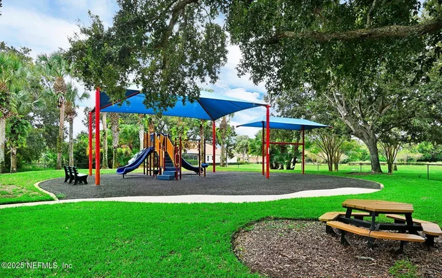 a view of a park with swings and slides