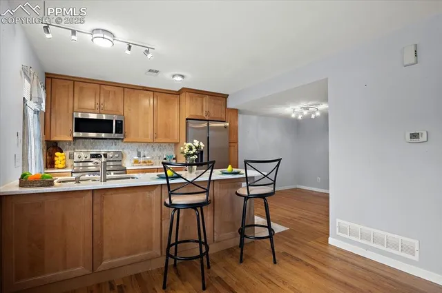 a kitchen with a stove and a window
