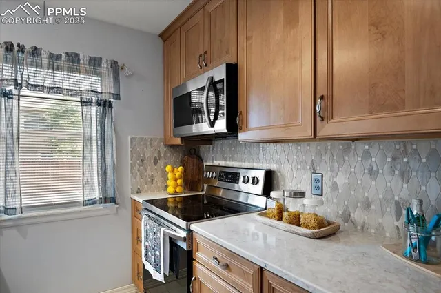 a kitchen with stainless steel appliances granite countertop a sink stove and cabinets