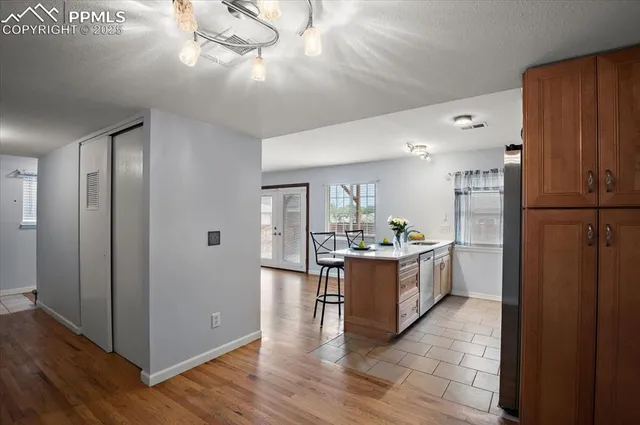 a kitchen with a refrigerator and a stove top oven