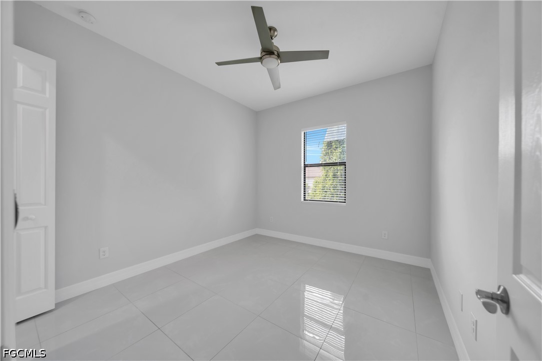 3509 38th Street Southwest Lehigh Acres, FL 33976 - Photo 27 of 47 an empty room with windows and fan