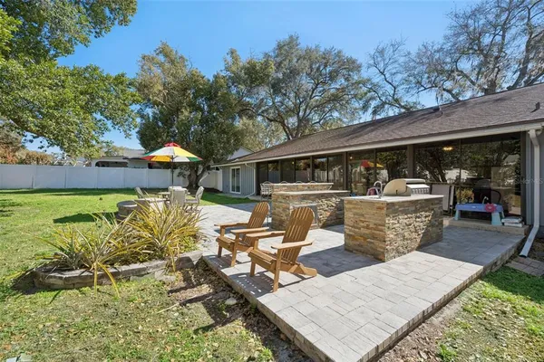a view of a patio with couches table and chairs and potted plants