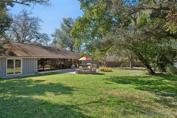a view of a house with a yard and sitting area