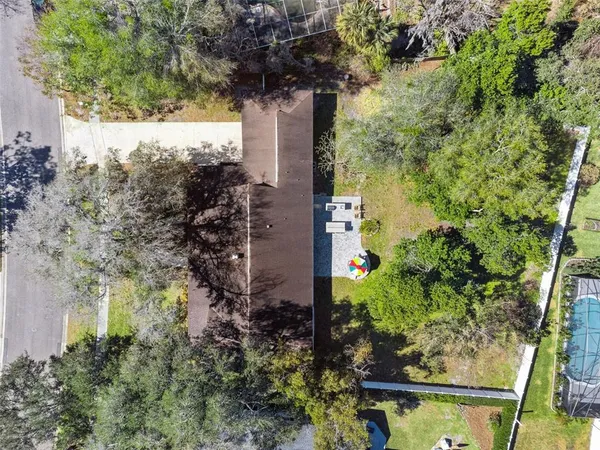 an aerial view of a residential houses with yard