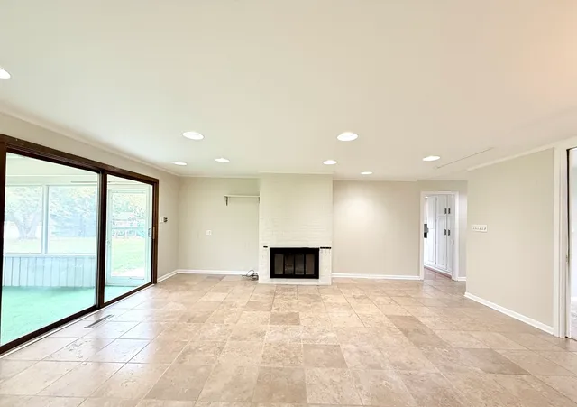 a view of room with large windows