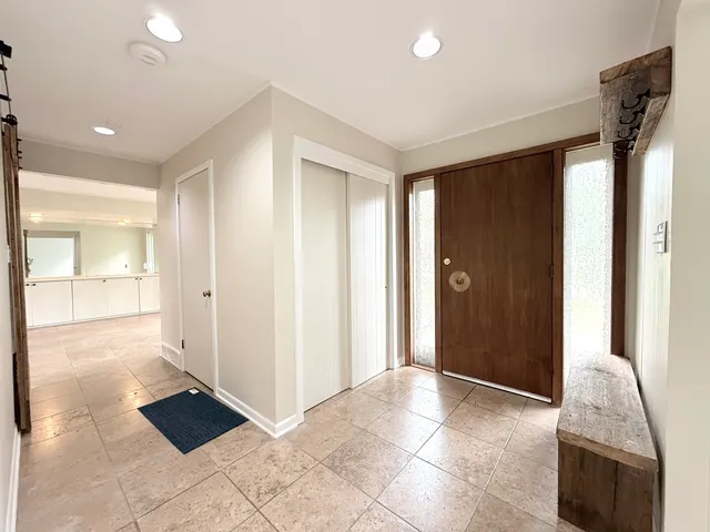 a kitchen with stainless steel appliances kitchen island granite countertop a refrigerator and a stove top oven