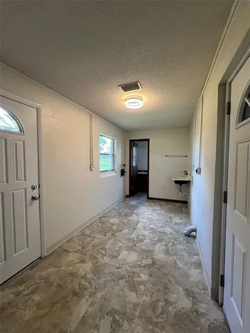 a view of a big room with closet and windows