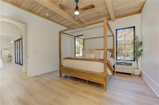 a view of a room with wooden floor and porch with a garden