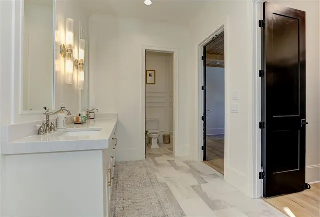 a large kitchen with stainless steel appliances kitchen island a large counter top and a wooden floors