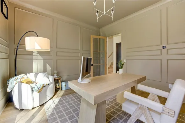 a front view of a house with yard and green space