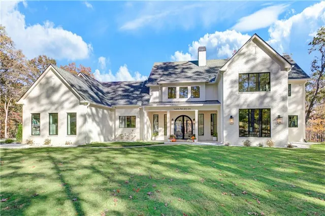 a living room with furniture a fireplace and a floor to ceiling window