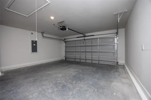 an empty room with windows and cabinet