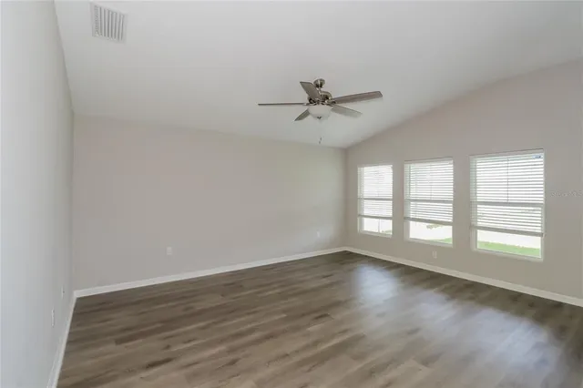 a view of wooden floor and windows in a room