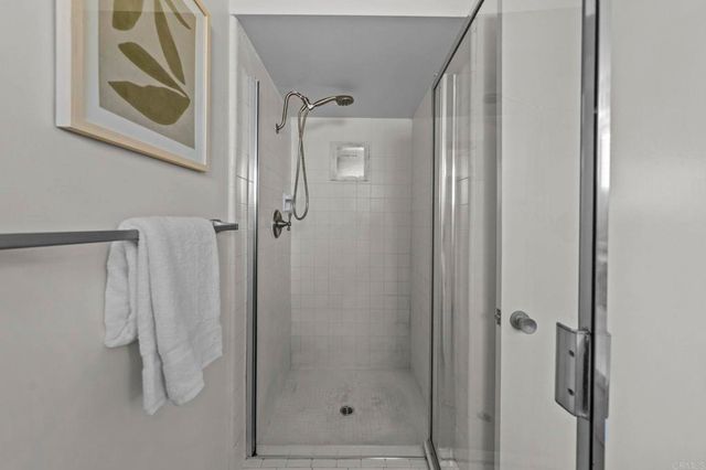 a spacious bathroom with a granite countertop sink a mirror and shower