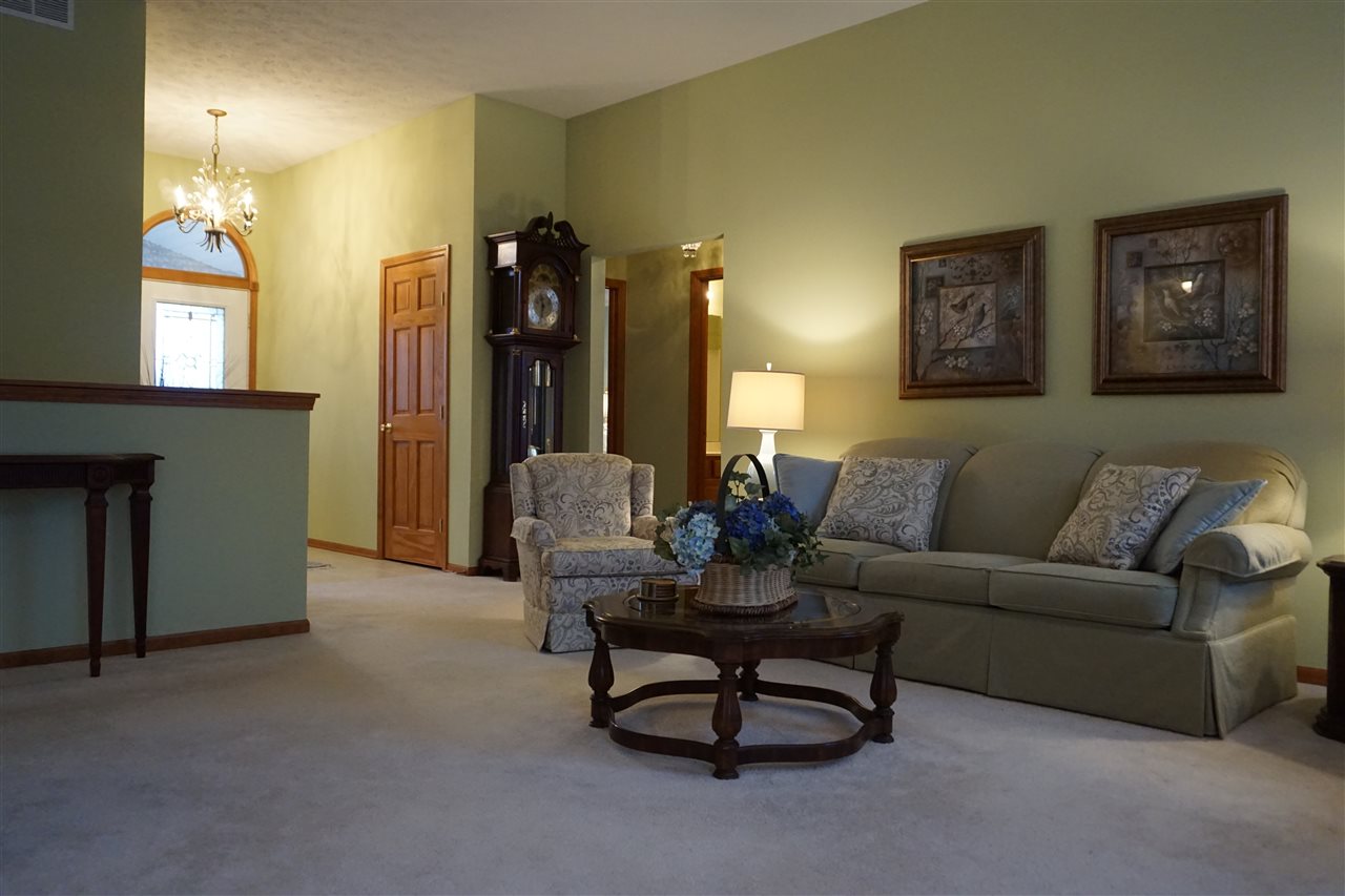 11123 Chicory Ridge Way Roscoe, IL 61073 - Photo 16 of 23 a living room with furniture and a chandelier